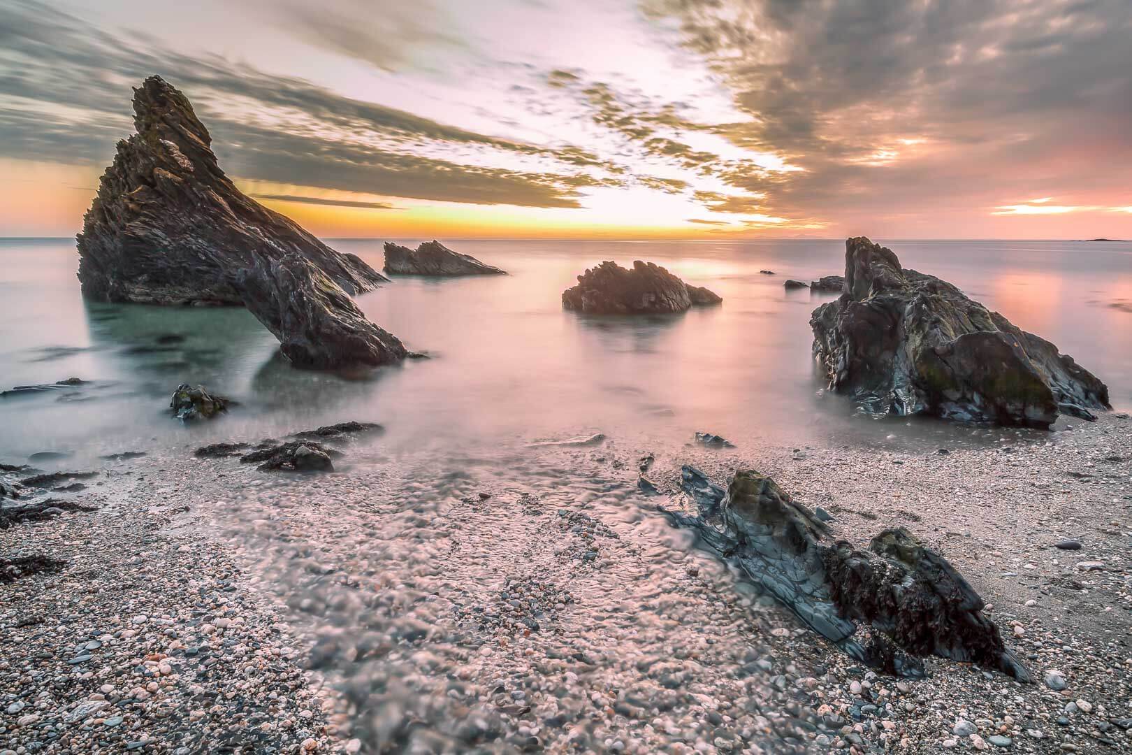 Landscape Photography Isle of Man, large, jagged, monolithic rocks protect a coastal hideaway. title=