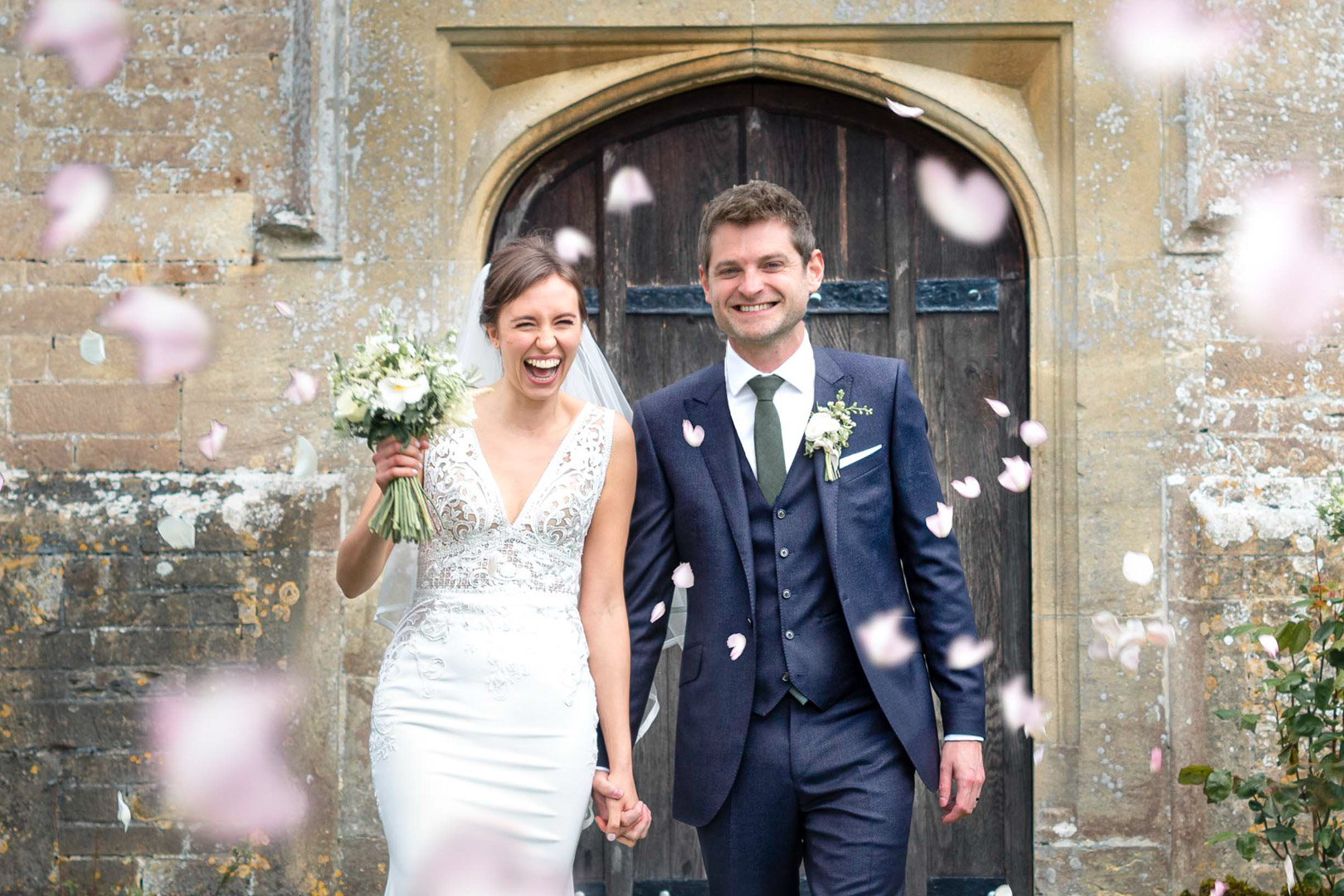 Bride & Groom showered with pink heart shaped confetti